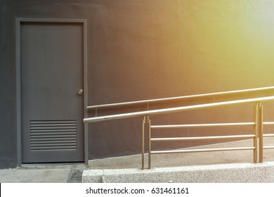 Black Door Of Building With Wheelchair Ramp