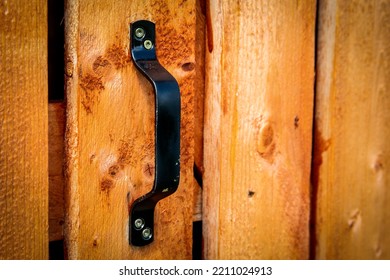 Black Door Handle On Wooden Plank Door.