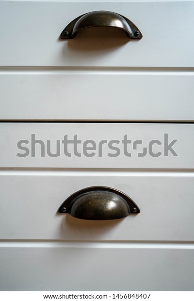 Black Drawer knobs on\
white texture wood