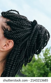 Black dreadlocks on european woman head. Afro braids hair style on white skin head. Side view.