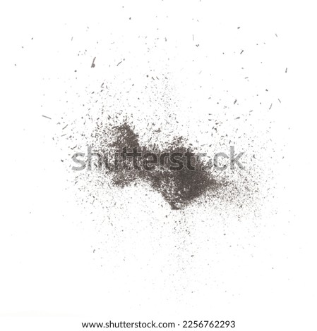 Black dried leave Tea explode. Small Fine size tea leaf flying explosion, Abstract cloud fly. Brown colored Teas splash throwing in Air. White background Isolated high speed shutter, throwing freeze