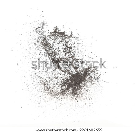 Black dried leave Tea explode. Small Fine size tea leaf flying explosion, Abstract cloud fly. Brown colored Teas splash throwing in Air. White background Isolated high speed shutter, throwing freeze