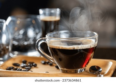 black drip coffee in glass cup, Barista making drip coffee by pouring spills hot water on coffee bean. Barista serve holding cup of hot black coffee or americano for serve on wooden table cafe shop - Powered by Shutterstock