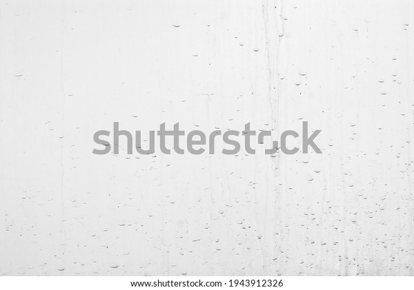 Black drops of dirt on a white background. Dirty\
wall after rain.
