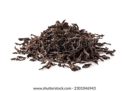Black dry tea leaves isolated on white background
