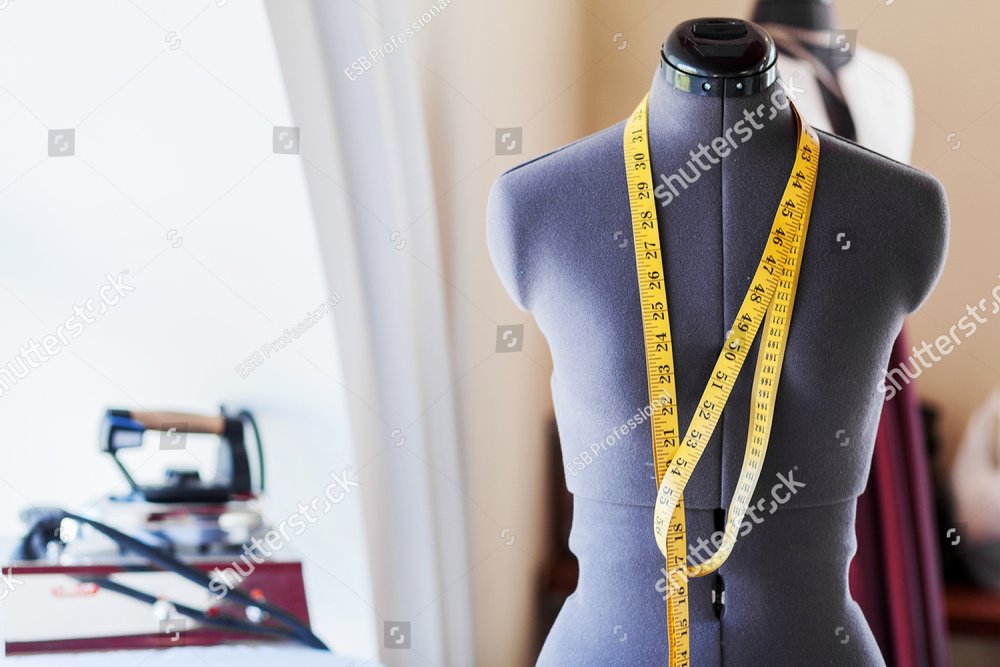 Black dummy with measuring tape in tailors studio