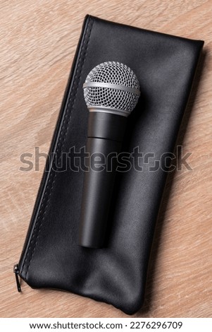 black dynamic microphone on black leather case  Stock photo © 