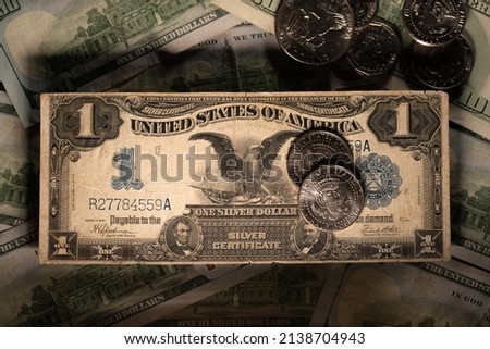 Black Eagle Dollar banknote. Antique, historic Dollar banknote. Half Dollar coins on Dollar bill