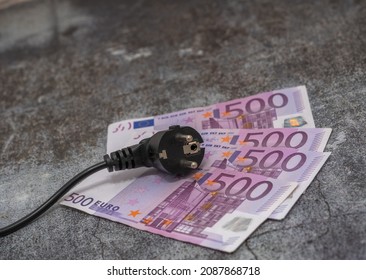 Black electric cable and 500 euro banknotes. expensive electricity