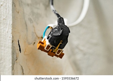 Black electric plug sockets with exposed wires on the white background. Dangerous. Unsafe. Kill. Bad. Industrial. Danger. Risk. Safety