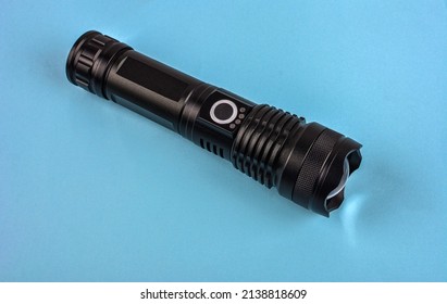 Black electric pocket flashlight, isolated on white .Black modern LED tactical flashlight isolated on white background