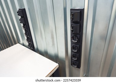 Black electrical outlet socket on a room wall - Shutterstock ID 2257423339