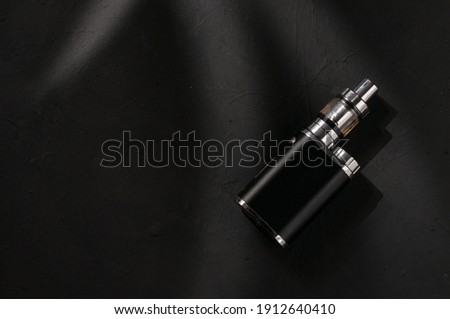 black electronic module in top view on a black textured background