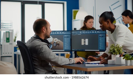 Black Employee And Project Manager Analysing Mechanical Metalic Parts, 3D Cad Program With Gears Shape, Software With New Prototypes. Industrial Engineer And Afro Colleague Working In Creative Office