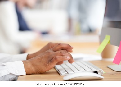 Black Employee Sitting At Office Desk Typing Business Message Close Up Woman Hands Texting Email Using Wireless Keyboard And Computer. Worker Contacting Client By Internet Online Communication Concept