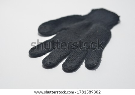Black empty nitrile protective glove isolated on white 