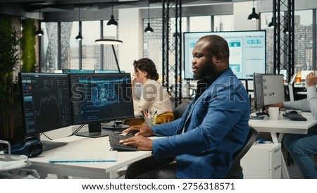 Black engineer uses artificial intelligence systems for automation and data mining, employing neural networks for innovation and digitalization. Multinational company functions with AI.