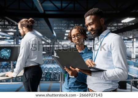 Black engineering team doing maintenance on server rigs for AI processing tasks. Server hub coworkers managing storage arrays supporting machine learning training workflows, high tech.
