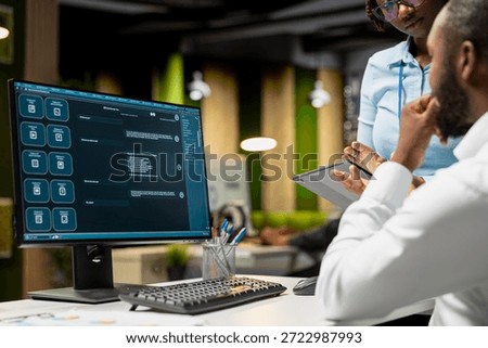 Black IT engineers team developing app and software algorithm on pc, working in the office late at night. Specialists use digital tools and focuses on script engineering and coding.