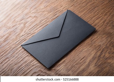 Black Envelope On  Wooden Table