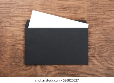 Black Envelope On  Wooden Table