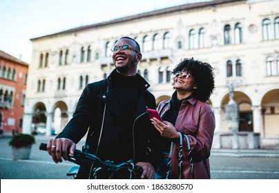 Black Ethnic Couple With Bicycles Around The Streets Of An Italian City.
