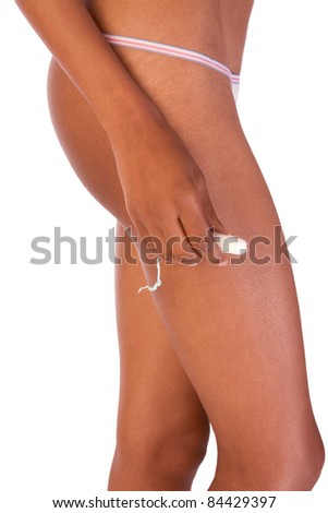 black ethnic woman hips and her hand holding white vaginal cotton tampon