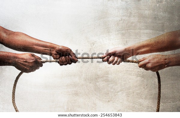 black\
ethnicity arms with hands pulling rope against white Caucasian race\
person in stop racism and xenophobia concept, immigration and\
multiracial  respect isolated on grunge\
background