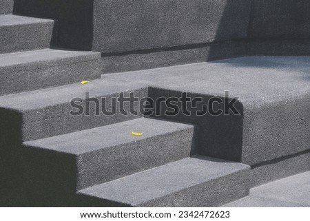 Black Exposed Aggregate Finish cobble Stone Staircase of outdoor stage with light and shadow on surface. Geometric architecture minimal background design concept