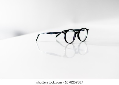 Black Eyeglasses Closeup. Eye Glasses.Modern Style Eyeglasses. Round Glasses With Transparent Lenses. Vintage Glasses Side View. Close Up Eyeglasses With Blurry Technique.Fashion Accessories