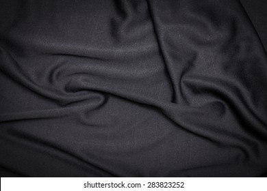 Black fabric background in the folds