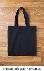 Black Fabric Bag On Wooden Background