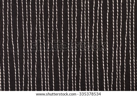Black fabric with white stitches background texture