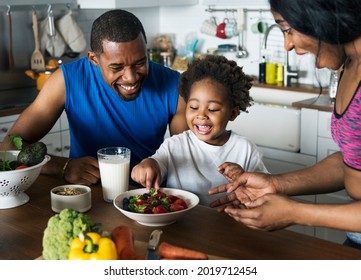 Black family eating healthy food together