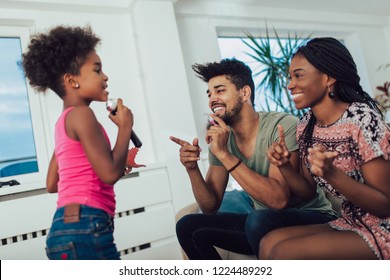 Black Family Enjoy Singing Karaoke At Home.