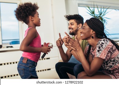 Black Family Enjoy Singing Karaoke At Home.