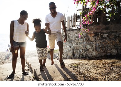 Black Family Enjoying Summer Together At The Beach