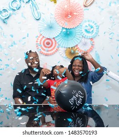 Black family at a gender reveal baby shower - Shutterstock ID 1483570193