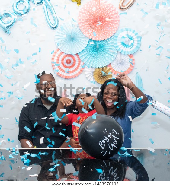 Black family at a\
gender reveal baby shower