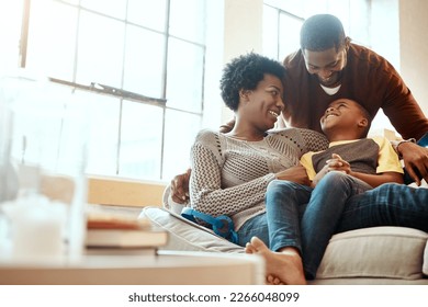 Black family, happy and relax on sofa with boy and parents, hug and laughing in their home together. Happy family, mother and father playing with their son on a couch, content and joy in living room