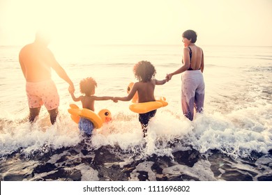 Black Family Having Fun On The Beach