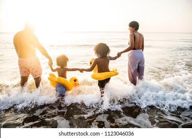 Black Family Having Fun On The Beach