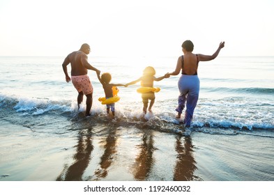 Black Family Having Fun On The Beach