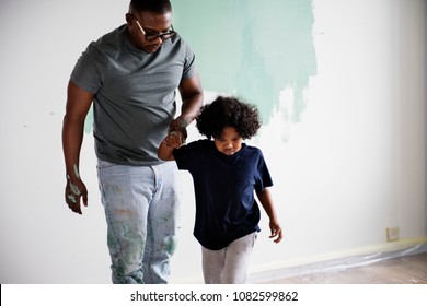 Black Family Painting House Wall