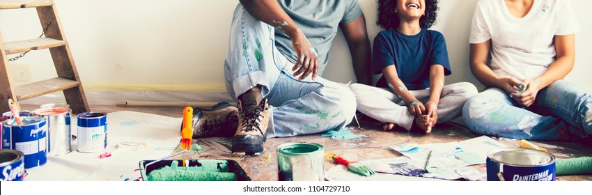 Black Family Painting The House Wall