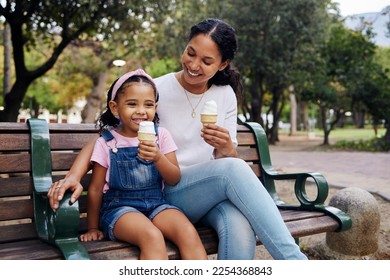 Black family, park and ice cream with a mother and daughter bonding together while sitting on a bench outdoor in nature. Summer, children and garden with a woman and girl enjoying a sweet snack - Powered by Shutterstock