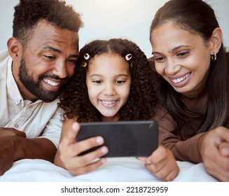 Black Family, Phone And Child On Bed For Video, Smile Or Happy For Streaming, Cartoon Or Movie. Mom, Dad And Kid With Smartphone In Bedroom To Game, Internet Or Watching To Relax, Happiness Or Play