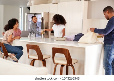 Black Family In Their Kitchen, Unpacking Groceries And Putting Them Away Together