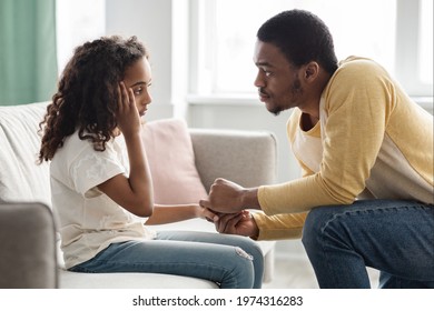 Black Father Comforting His Upset Girl Kid, Side View, Home Interior. Attentive African American Dad Consoling Sad Daughter After Quarrel. Fatherhood, Parenthood, Family Relations Concept