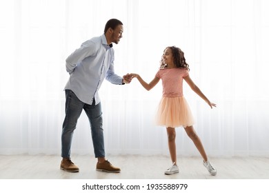 Black Father And Daughter Dancing At Home